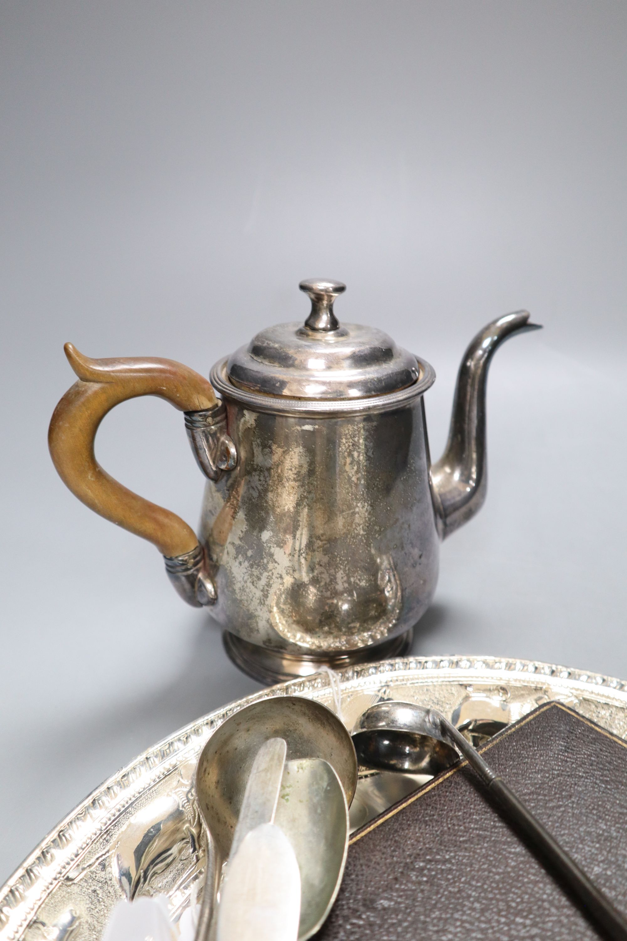 An Eastern embossed plated tray, a cased plated nut and grape set, a plated coffee pot, a silver sauce ladle and sundries